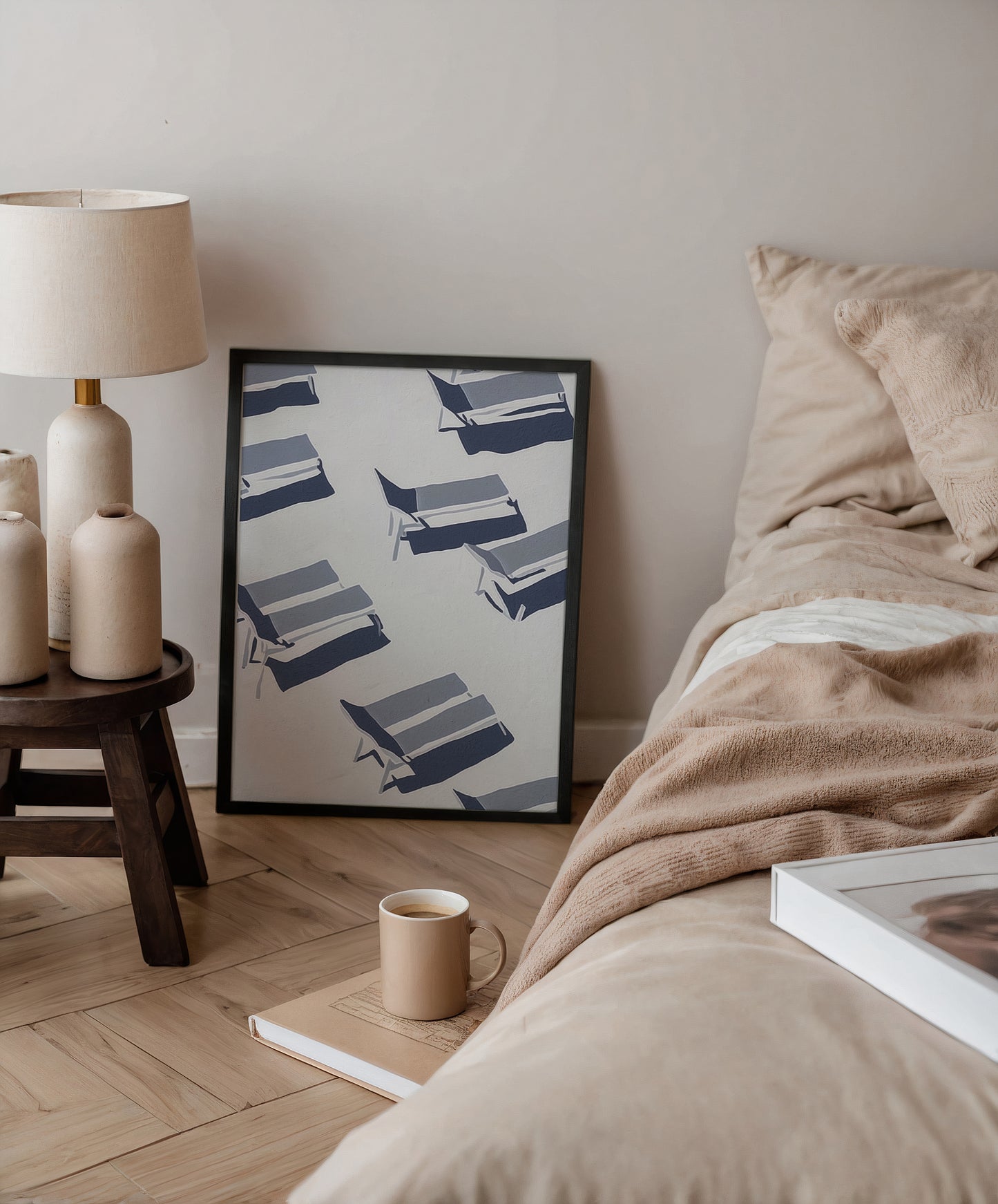 Cozy bedroom with a bed, lamp, and framed artwork on the wall.