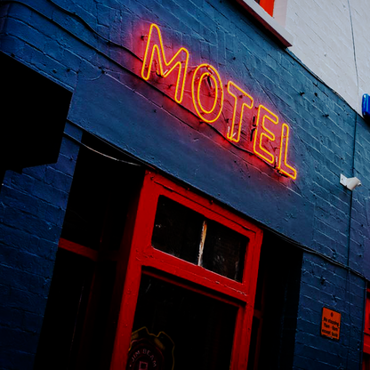 Motel neon sign on blue building