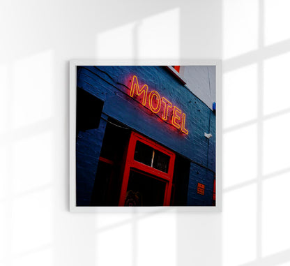 Motel neon sign on blue building