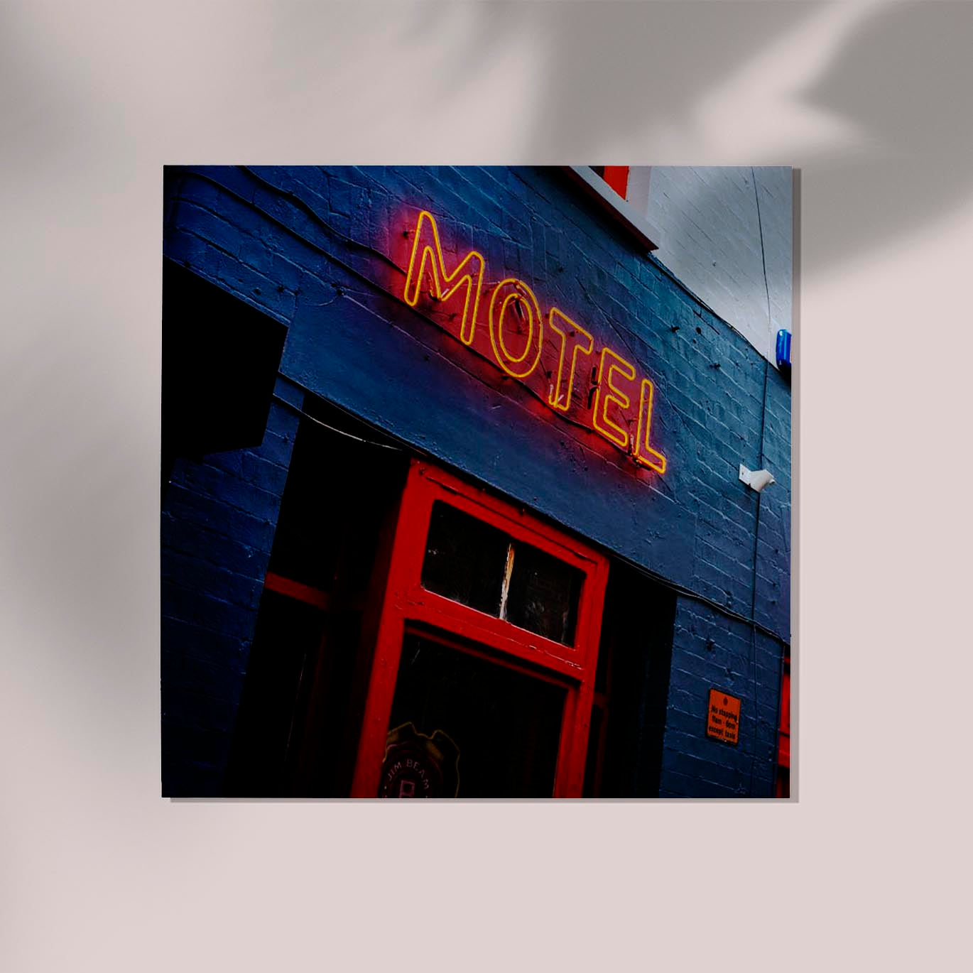 Motel neon sign on blue building