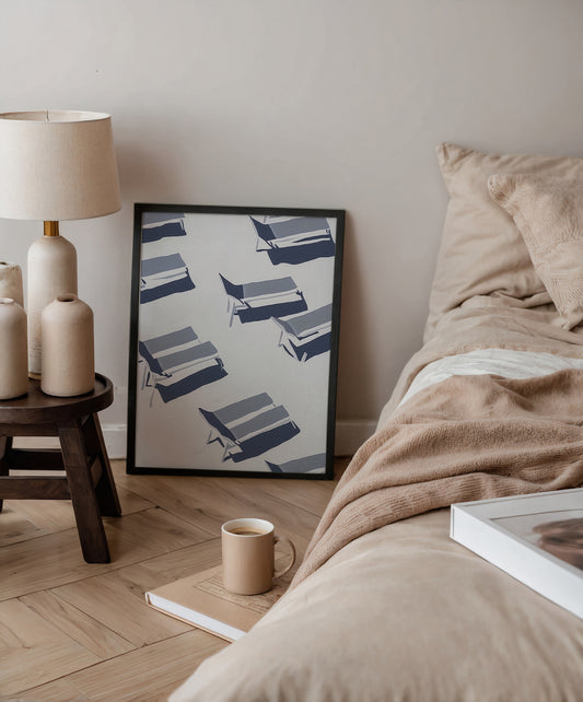 Cozy bedroom with a bed, lamp, and framed artwork on the wall.